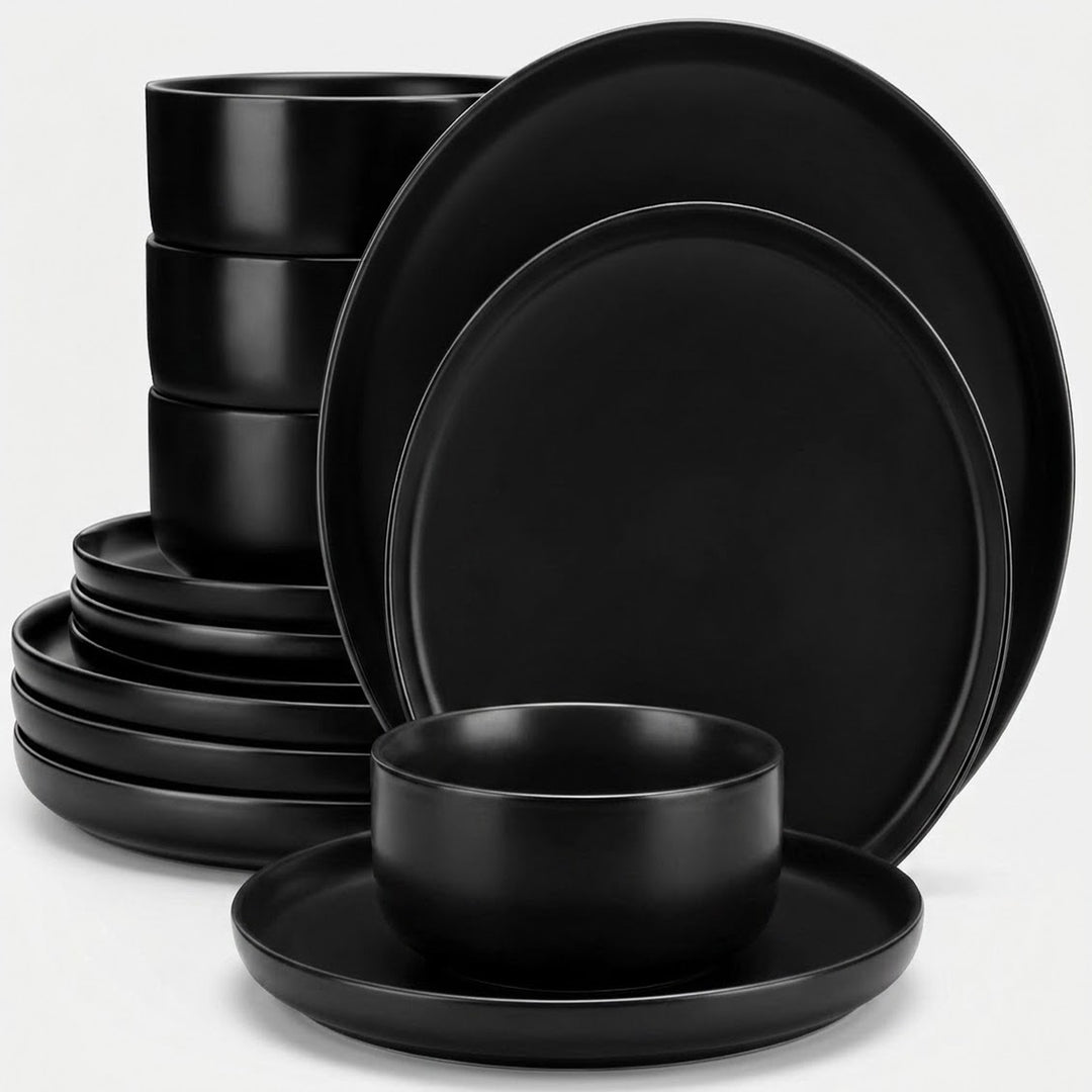 A matte black dinnerware set including plates and bowls, arranged on a clean white background.