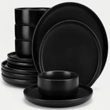 A matte black dinnerware set including plates and bowls, arranged on a clean white background.