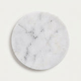 A round white marble coaster with natural gray and black veining, shown on a clean off-white background.