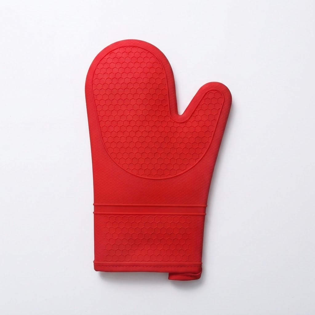 A single red silicone oven mitt with a textured grip pattern, shown flat against a light gray background.