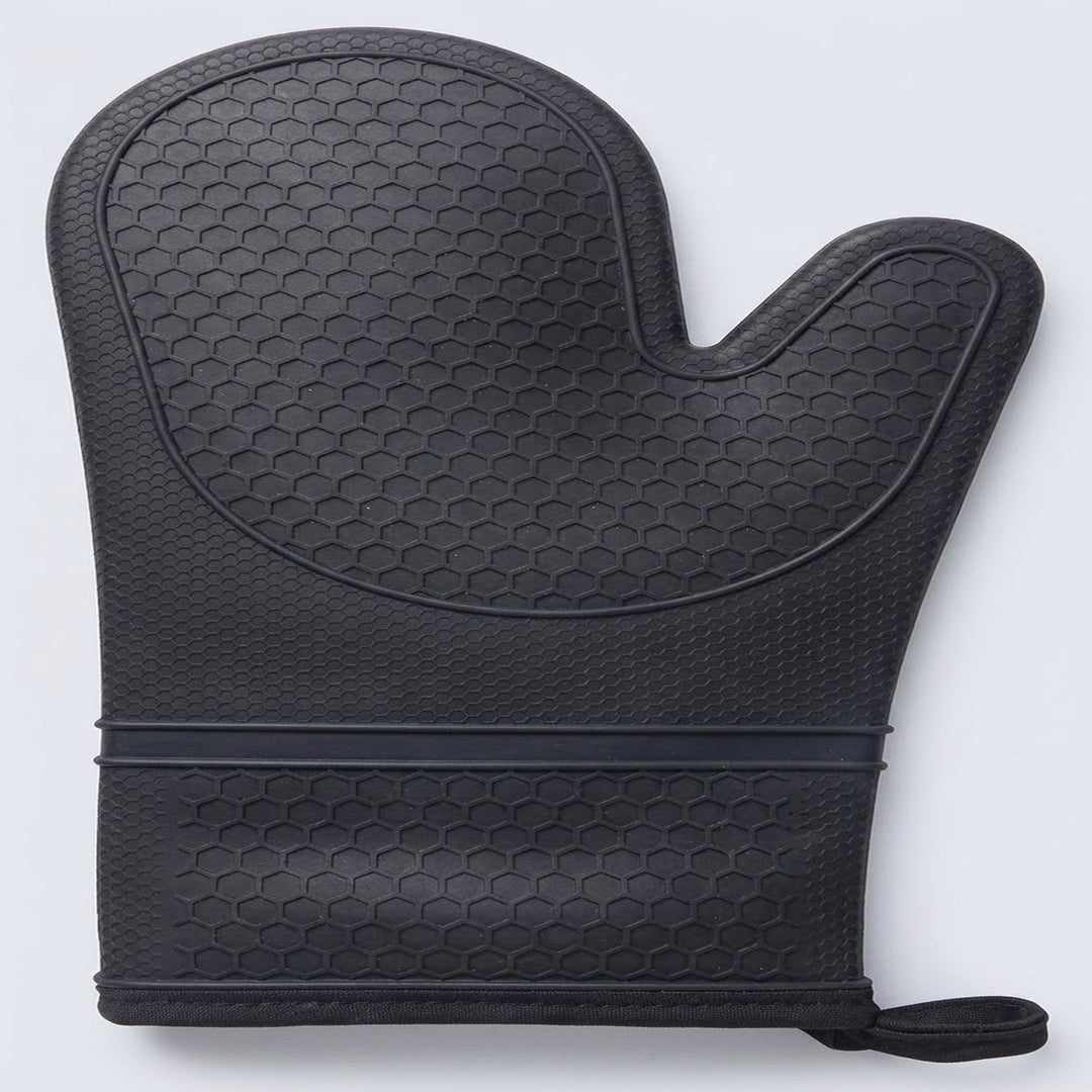 A black silicone oven mitt with a textured honeycomb pattern, featuring a built-in wrist strap and pull tab, shown on a light gray background.
