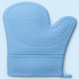 A light blue silicone oven mitt with a raised honeycomb texture, featuring a wrist strap with a small pull tab, shown against a light blue background.