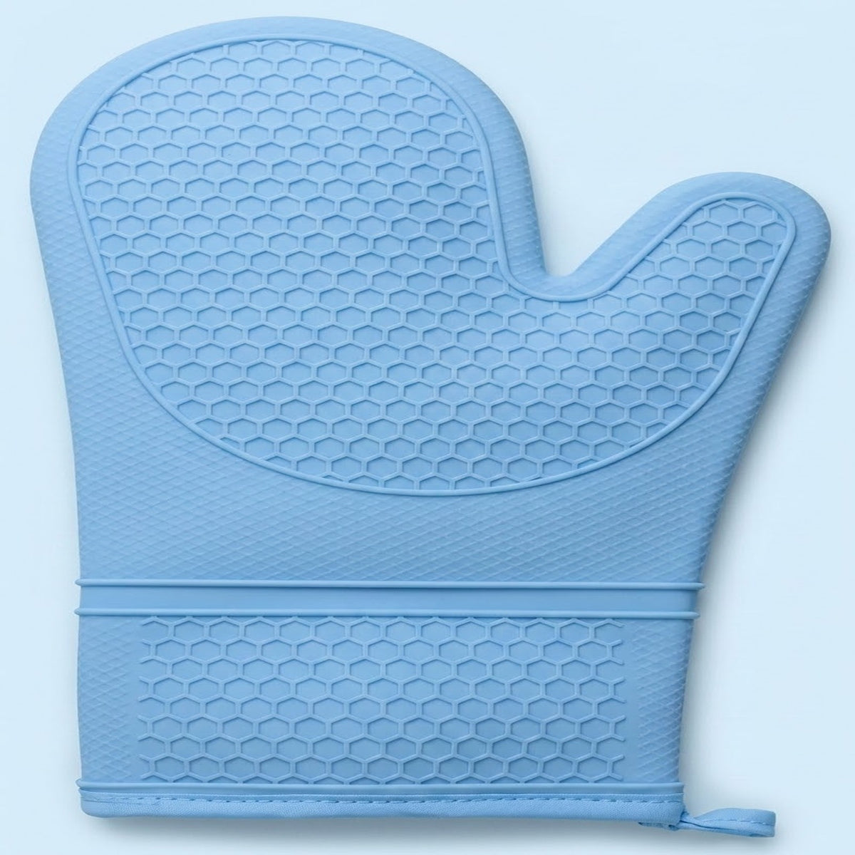 A light blue silicone oven mitt with a raised honeycomb texture, featuring a wrist strap with a small pull tab, shown against a light blue background.