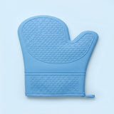 A light blue silicone oven mitt with a raised honeycomb texture, shown flat against a light blue background.