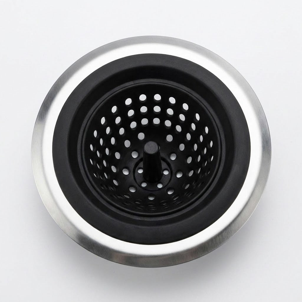 A top-down view of a kitchen sink drain assembly with a brushed silver metal rim, a black rubber gasket, and a black perforated basket strainer in the center, set against a plain light gray background.