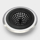 A round kitchen sink drain strainer with a brushed silver metal outer rim and a black inner mesh basket, shown on a light gray background.