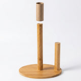 A bamboo cylindrical holder with a round base, featuring a central vertical post, a smaller right-side post, and a separate cardboard tube suspended above the center post on a white background.