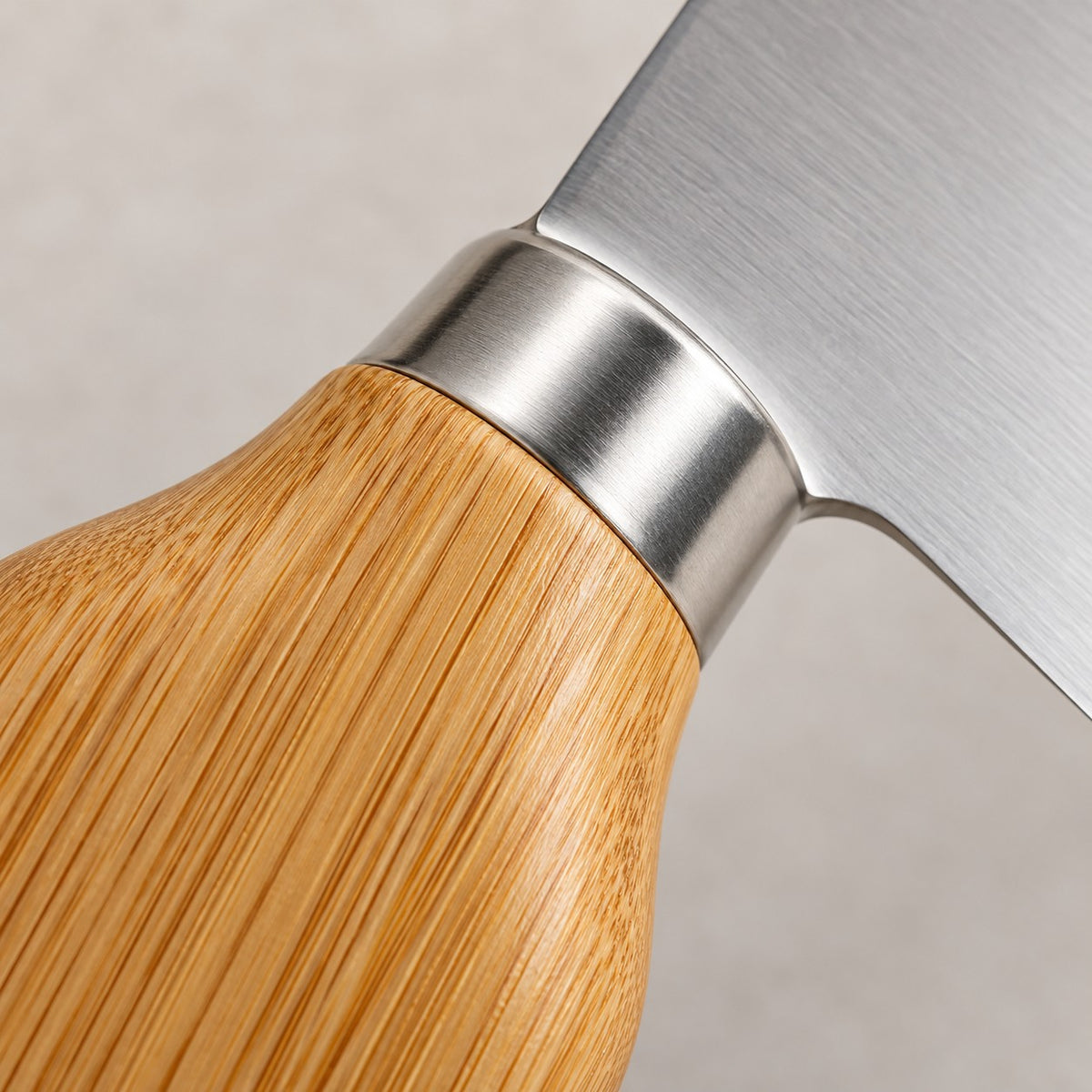 A close-up shows the bamboo grain, smooth silver collar, and stainless steel blade of the cheese knife set.