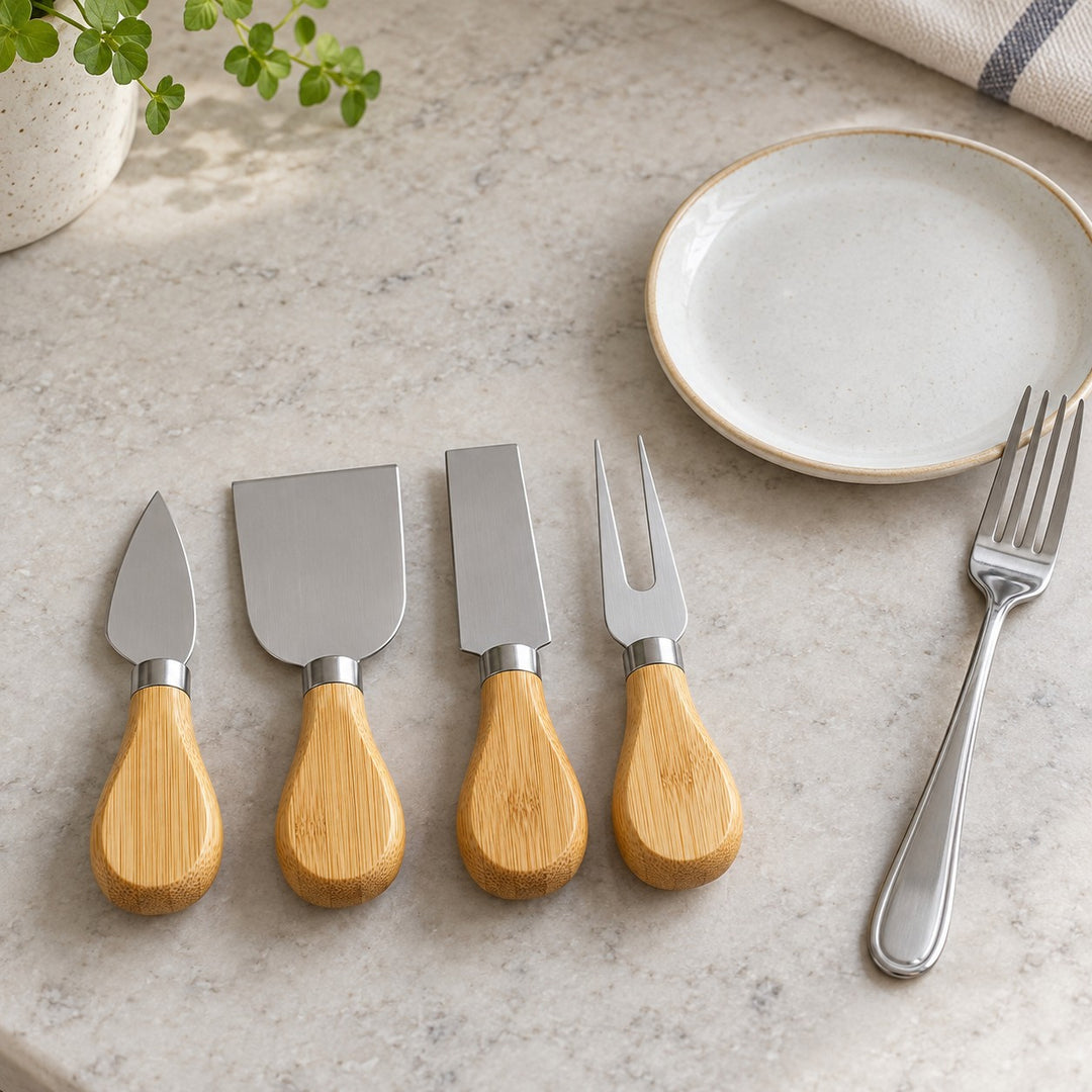 The compact four-piece cheese knife set sits beside a side plate and dinner fork for scale.
