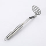 A stainless steel slotted potato masher with a long handle and hanging loop, shown on a plain white background.