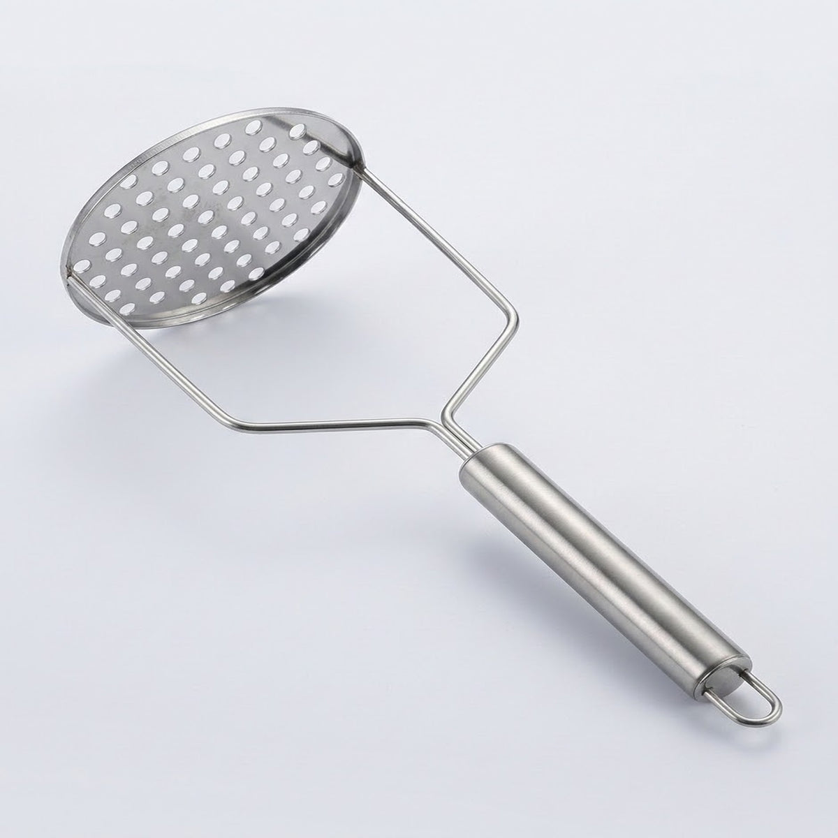 A stainless steel potato masher with a perforated oval head and a smooth cylindrical handle, shown on a light gray background.