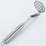 A stainless steel potato masher with a perforated oval head and a long cylindrical handle, shown diagonally on a plain white background.
