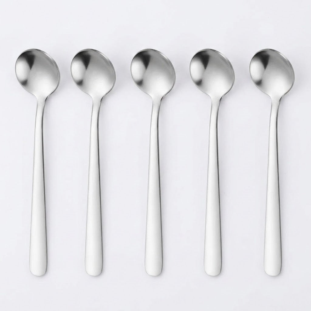 Five stainless steel spoons aligned vertically side-by-side on a clean, light gray background.