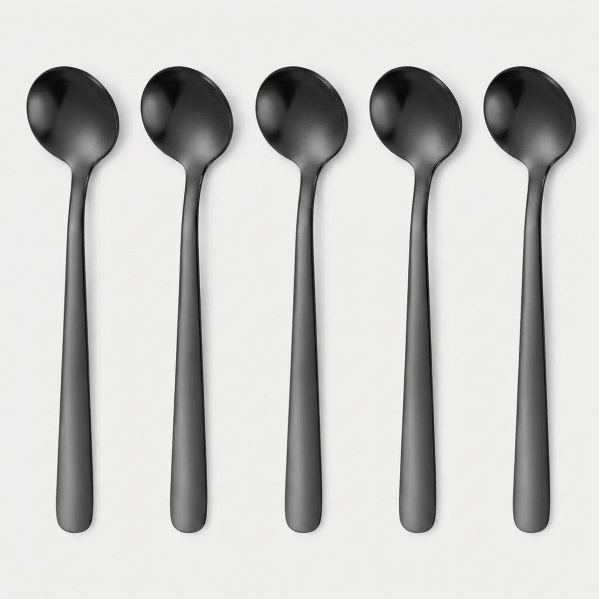 Five matte black metal spoons arranged vertically in a row on a light gray background.