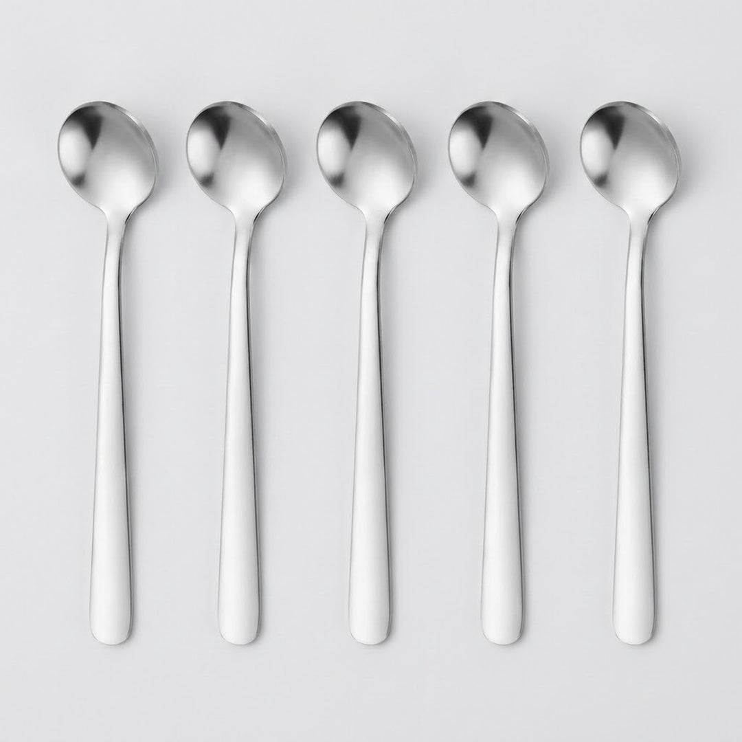 Five polished stainless steel spoons aligned vertically in a row on a light gray background.