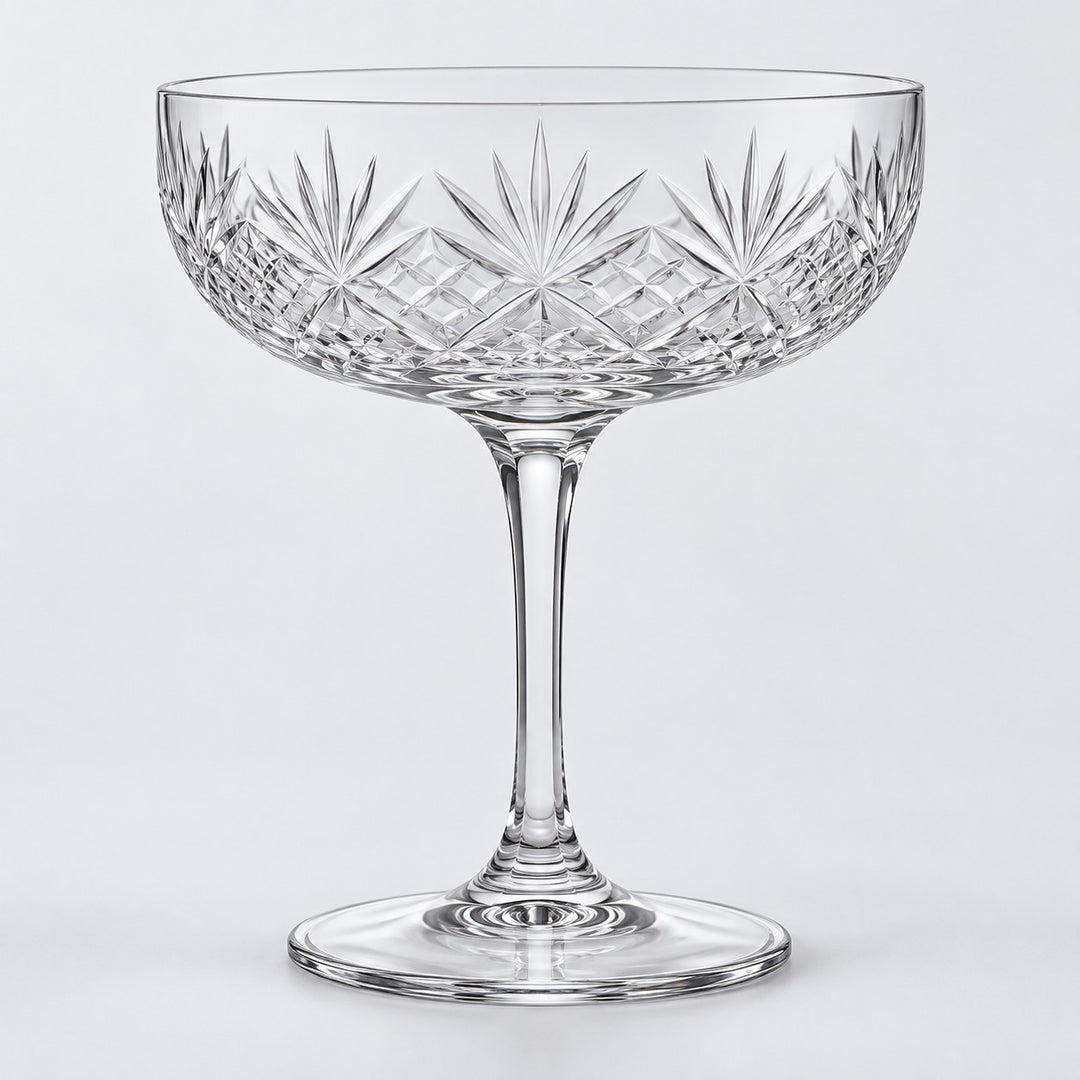The No Gold Rim coupe cocktail glass shows its clear edge on a pale gray studio background.