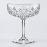 The No Gold Rim coupe cocktail glass shows its clear edge on a pale gray studio background.