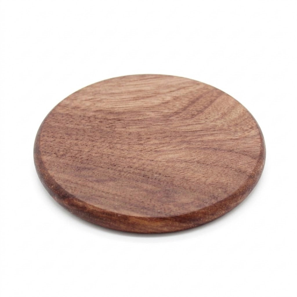 A round wooden serving board or coaster with a smooth, polished surface and visible wood grain, shown on a plain white background.