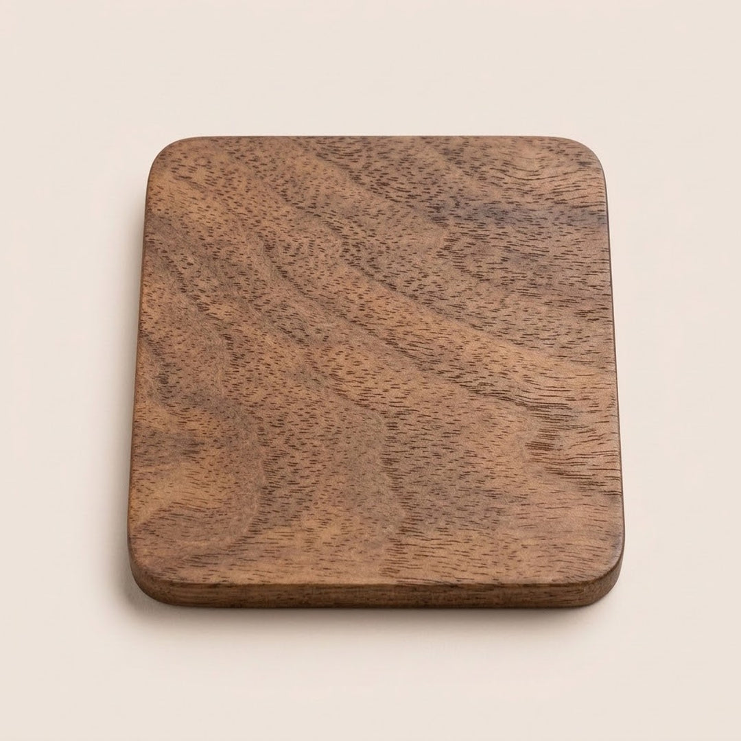 A square wooden cutting board with rounded corners and a visible natural wood grain pattern, photographed from directly above on a light beige background.
