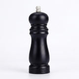 A single black pepper mill grinder with a silver metal top knob, photographed against a seamless white background.