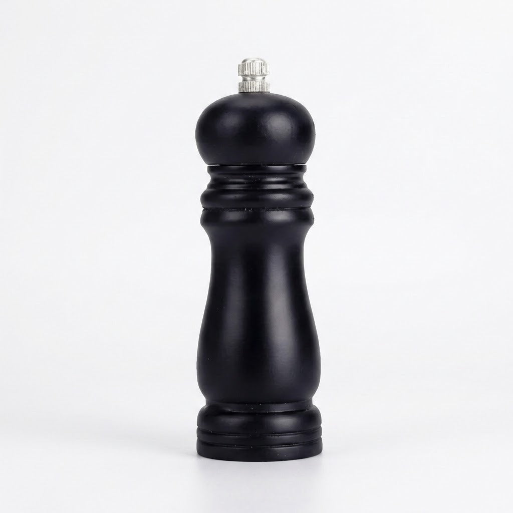 Black wooden pepper grinder with a contoured body and silver top knob stands on a white surface against a white background.