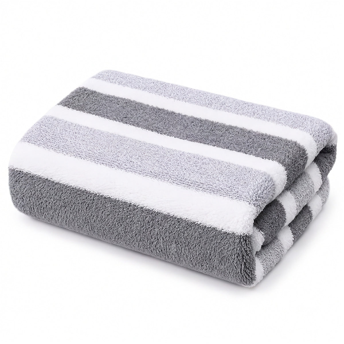 A folded plush towel with alternating dark gray, light gray, and white stripes sits against a plain white background.