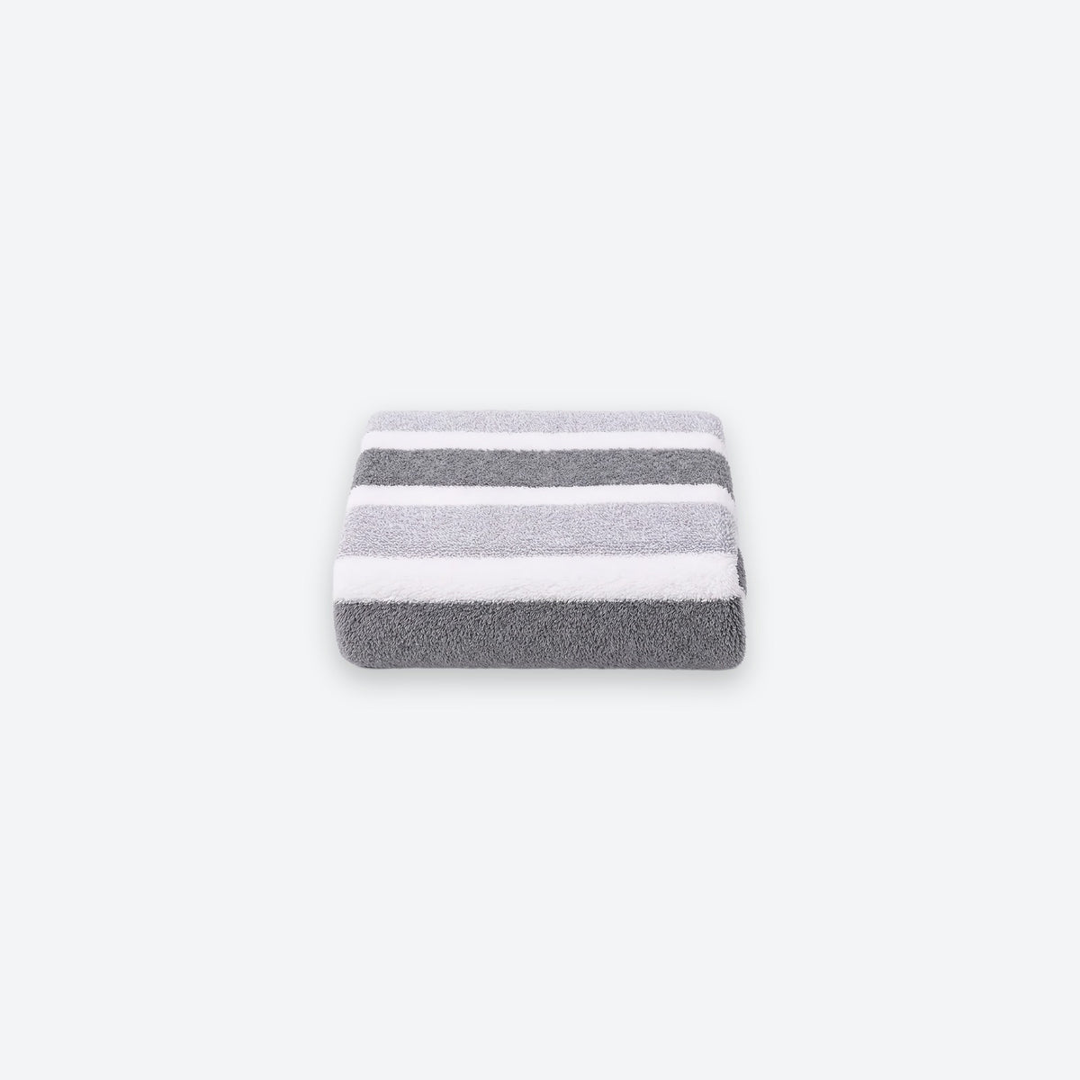 A neatly folded terry towel with broad gray and white stripes sits centered on a light gray background.