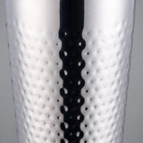 Close-up of the dimpled hammered texture covering the stainless steel body of the cocktail shaker.
