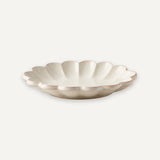 Brown flat shoe with a bow on a white background