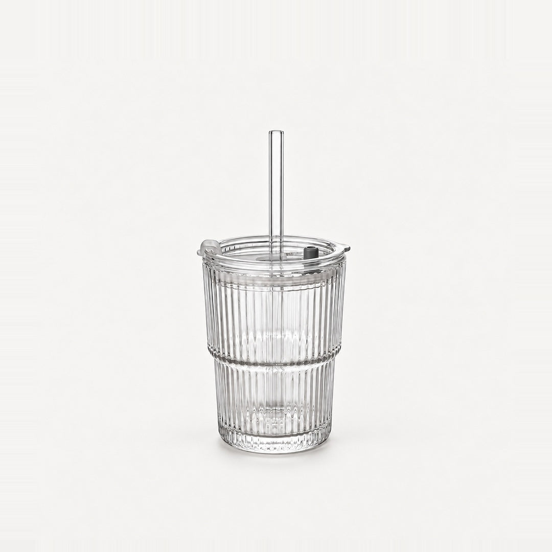 Empty clear ribbed glass tumbler with lid and straight glass straw, 13.5 fl oz (400 ml), on a light warm grey backdrop