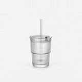 Empty clear ribbed glass tumbler with lid and straight glass straw, 13.5 fl oz (400 ml), on a light warm grey backdrop