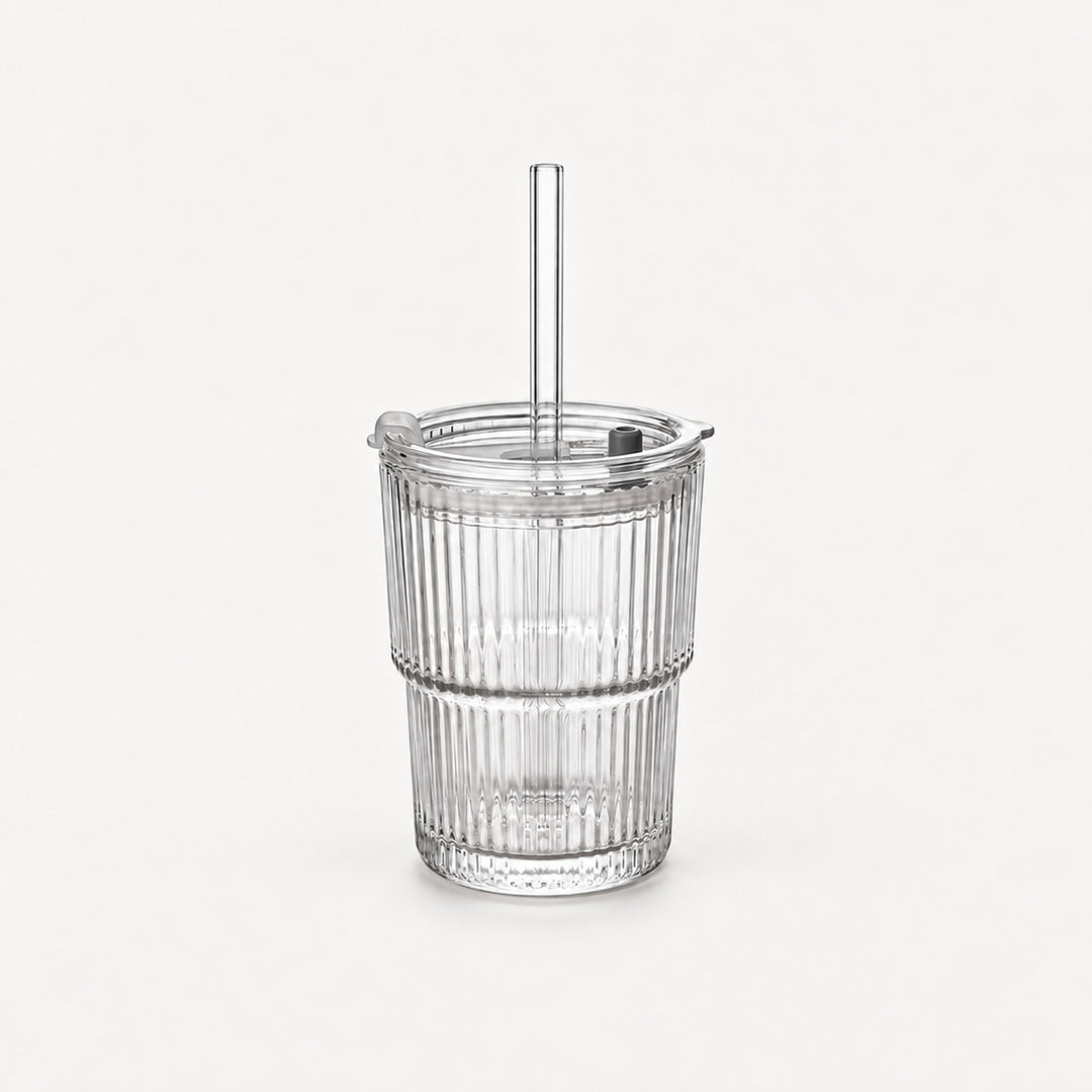 Empty clear ribbed glass tumbler with lid and straight glass straw, 20.3 fl oz (600 ml), on a light warm grey backdrop