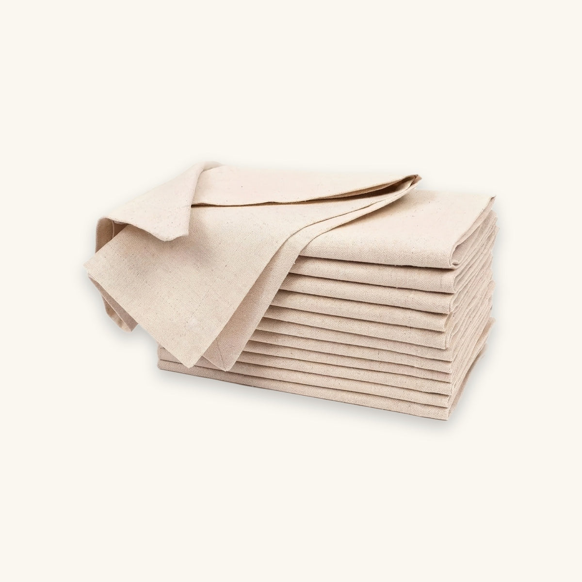 A stack of light beige linen napkins with one napkin draped on top, set against a solid off-white background.