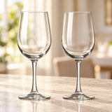 Pair of clear 320 ml soda-lime glass red wine glasses with rounded bowls and slender stems on a stone tabletop