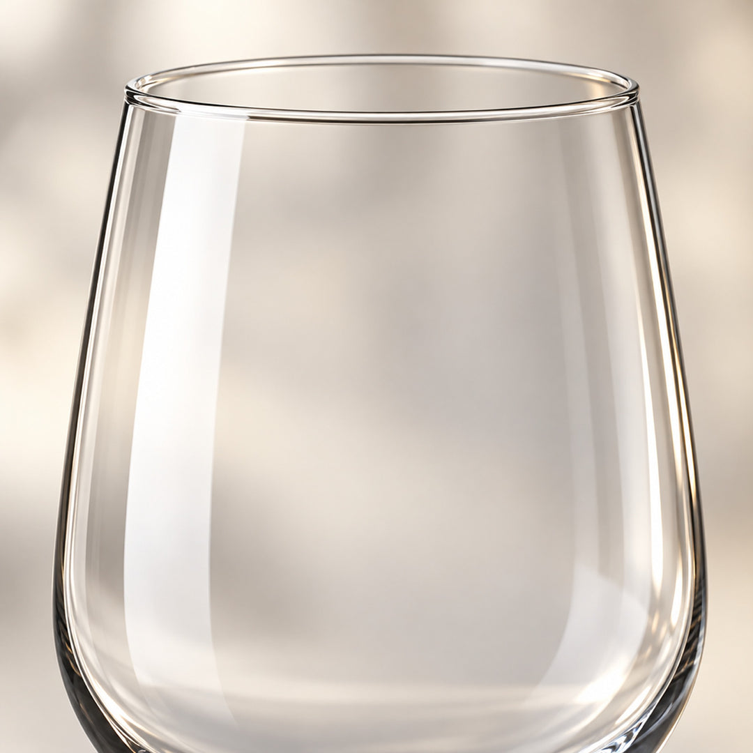 Close-up of the smooth, clear soda-lime glass bowl and rim of a red wine glass