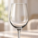 Clear red wine glass bowl and stem in soft window light