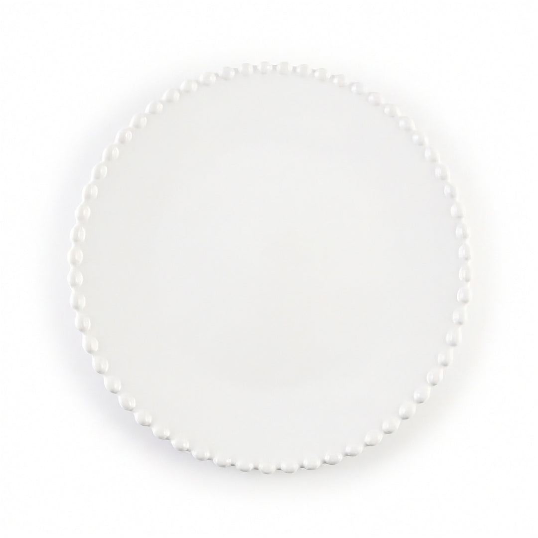 A round white plate with a delicate border of small white pearls, photographed from directly above on a clean white background.