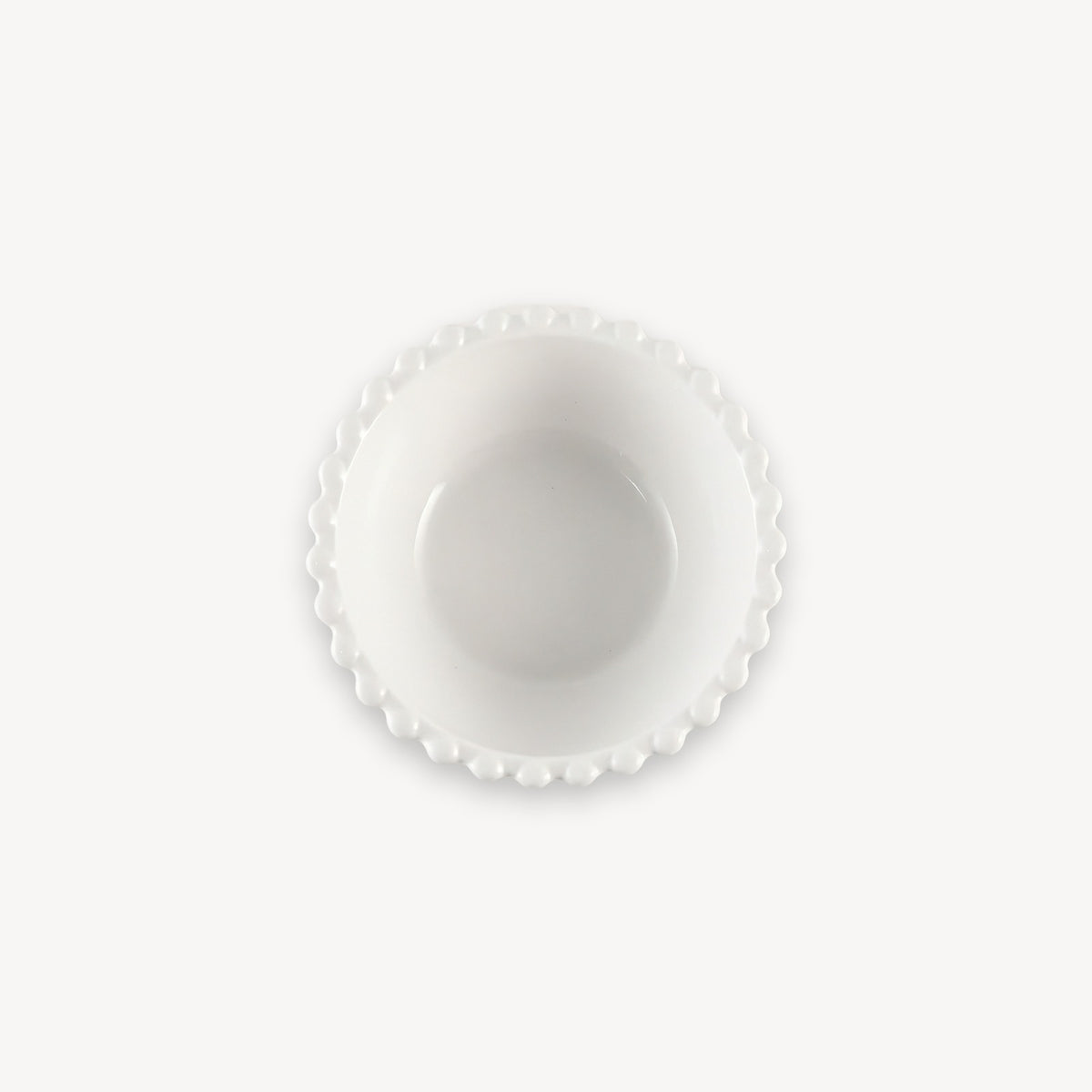 A white round bowl with a beaded rim and deep center is shown from above against a white background.