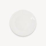 A white round plate with a glossy surface and beaded edge sits centered against a plain white background.