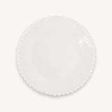 A glossy white round plate with a beaded rim is shown from above against a plain white background.