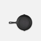 Black bare cast iron skillet, 8 in (20 cm), on a light grey backdrop