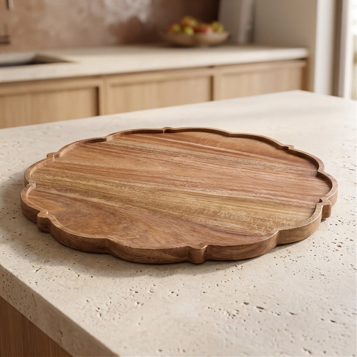 A scalloped-edge round wooden serving board with visible wood grain, placed on a light beige stone countertop in a kitchen setting.