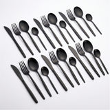 A set of matte black flatware, including knives, forks, spoons, and plastic cutlery, arranged neatly on a clean white background.