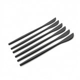 Five matte black plastic spreaders or spatulas arranged diagonally on a clean white background.