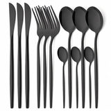 A 12-piece matte black cutlery set arranged neatly on a white background, including four dinner forks, four dinner knives, four dinner spoons, and four soup spoons.