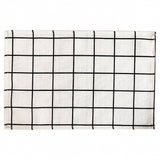 A square white fabric placemat or table runner featuring a black hand-drawn grid pattern, shown flat against a white background.