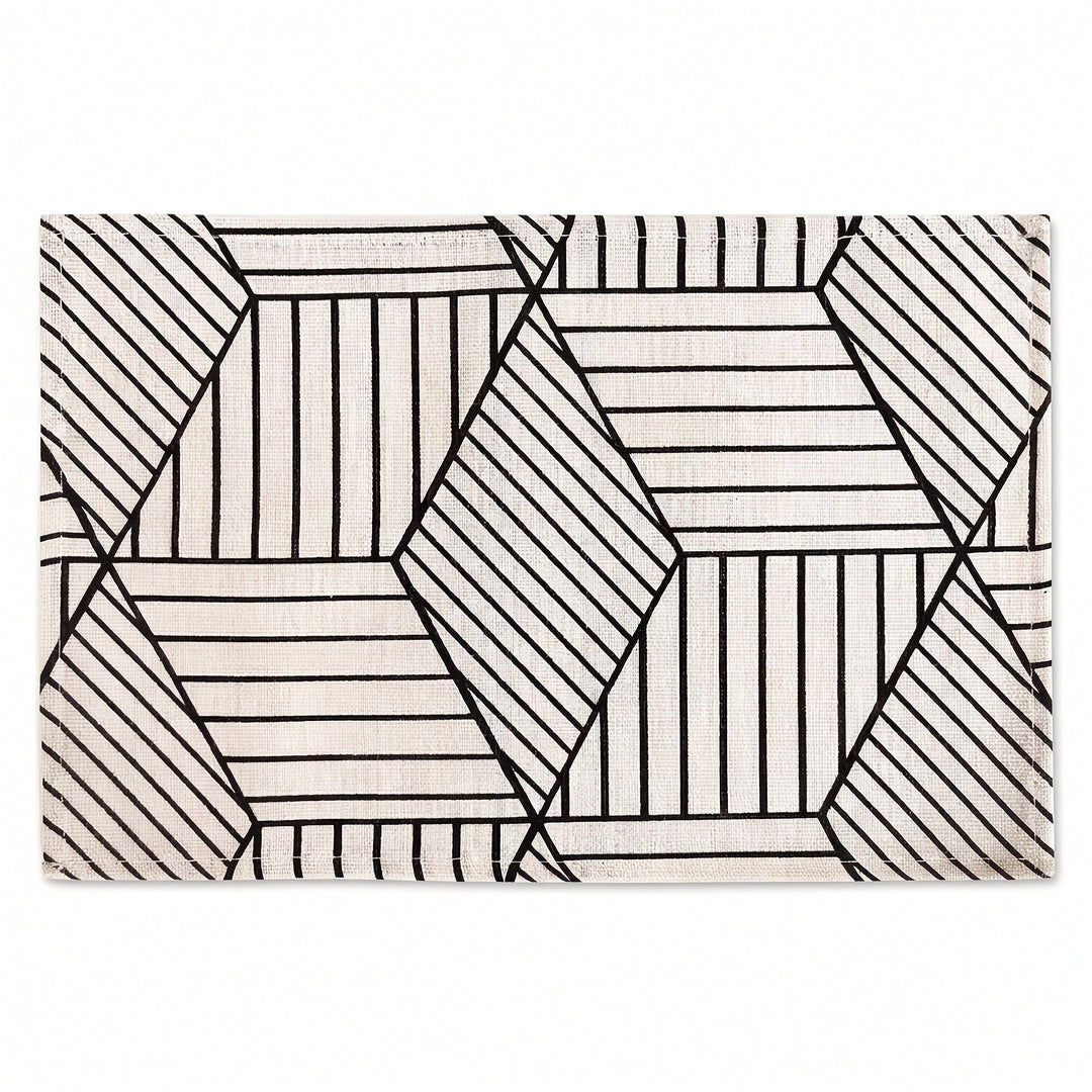 A rectangular area rug with a modern geometric pattern of black hand-drawn lines forming hexagons and diamonds on an off-white background.