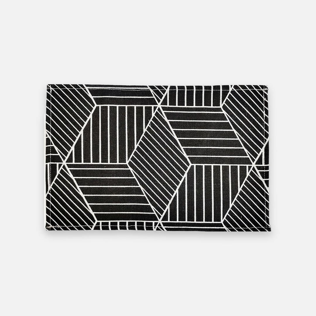 A rectangular black card holder or clutch featuring a white geometric pattern of intersecting lines and polygons, shown against a light gray background.