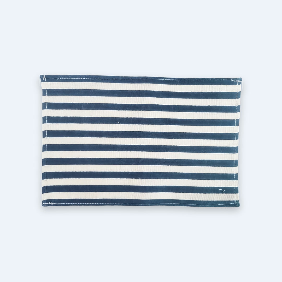 A rectangular fabric item with horizontal navy blue and off-white stripes, laid flat against a very light blue background.