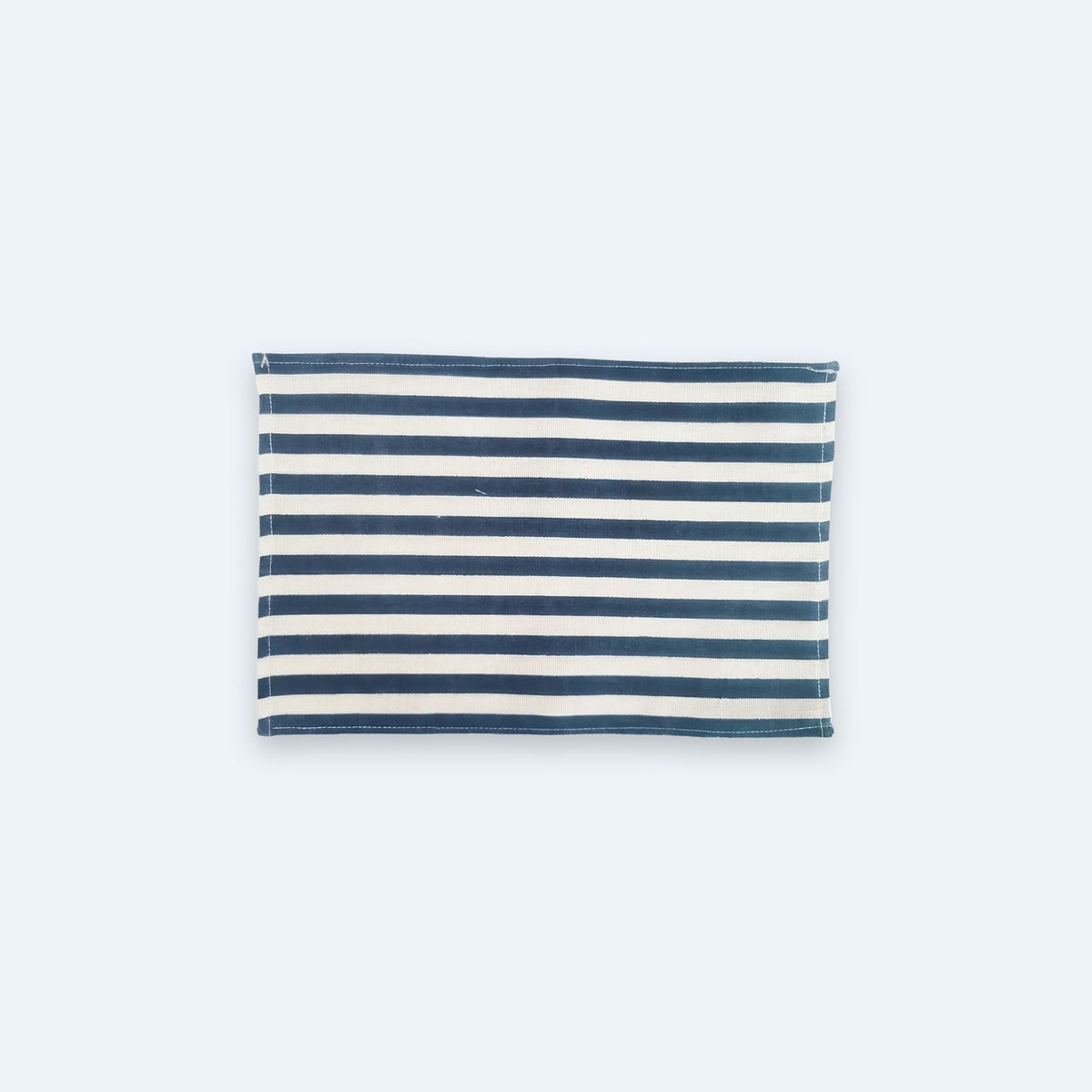 A rectangular fabric item, likely a small pouch or bag, featuring a horizontal navy blue and off-white stripe pattern, shown against a solid light gray background.